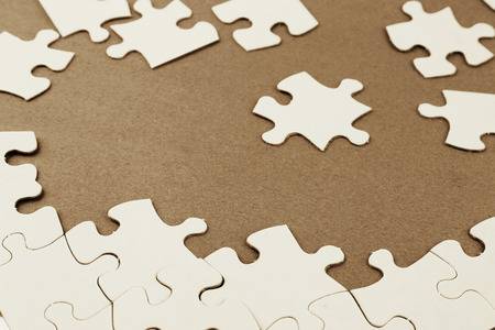 29595254-loose-jigsaw-puzzle-pieces-on-brown-background-.jpg